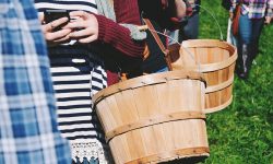 teens holding apple baskets with cellphone